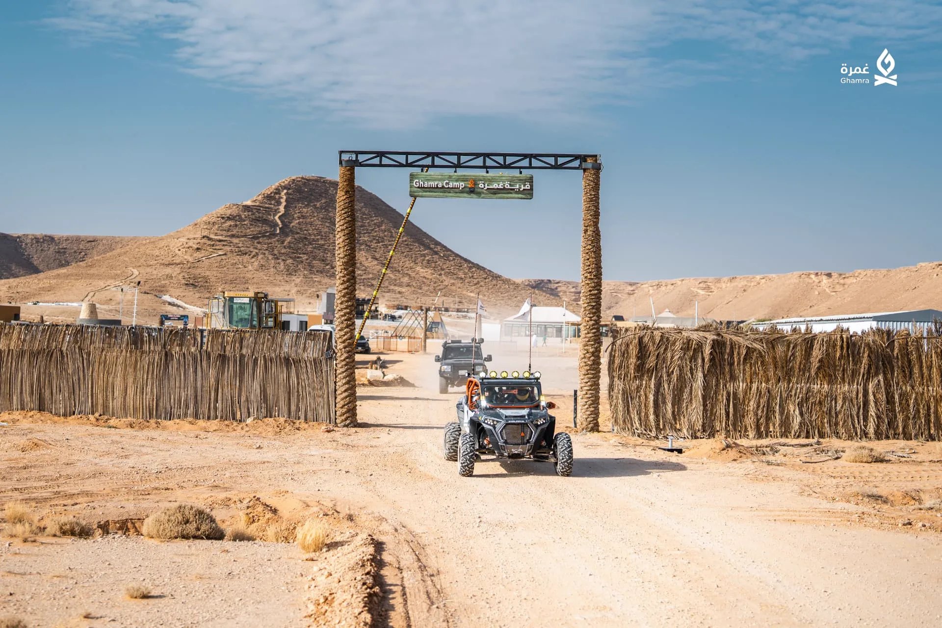 Buggy driving through the Ghamra Camp gate in the desert